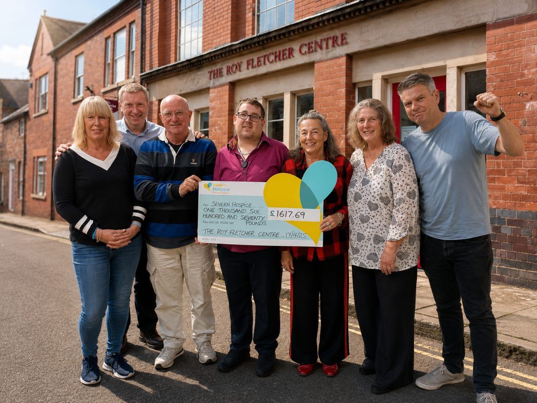 Staff and volunteers with a cheque for Severn Hospice outside the Centre